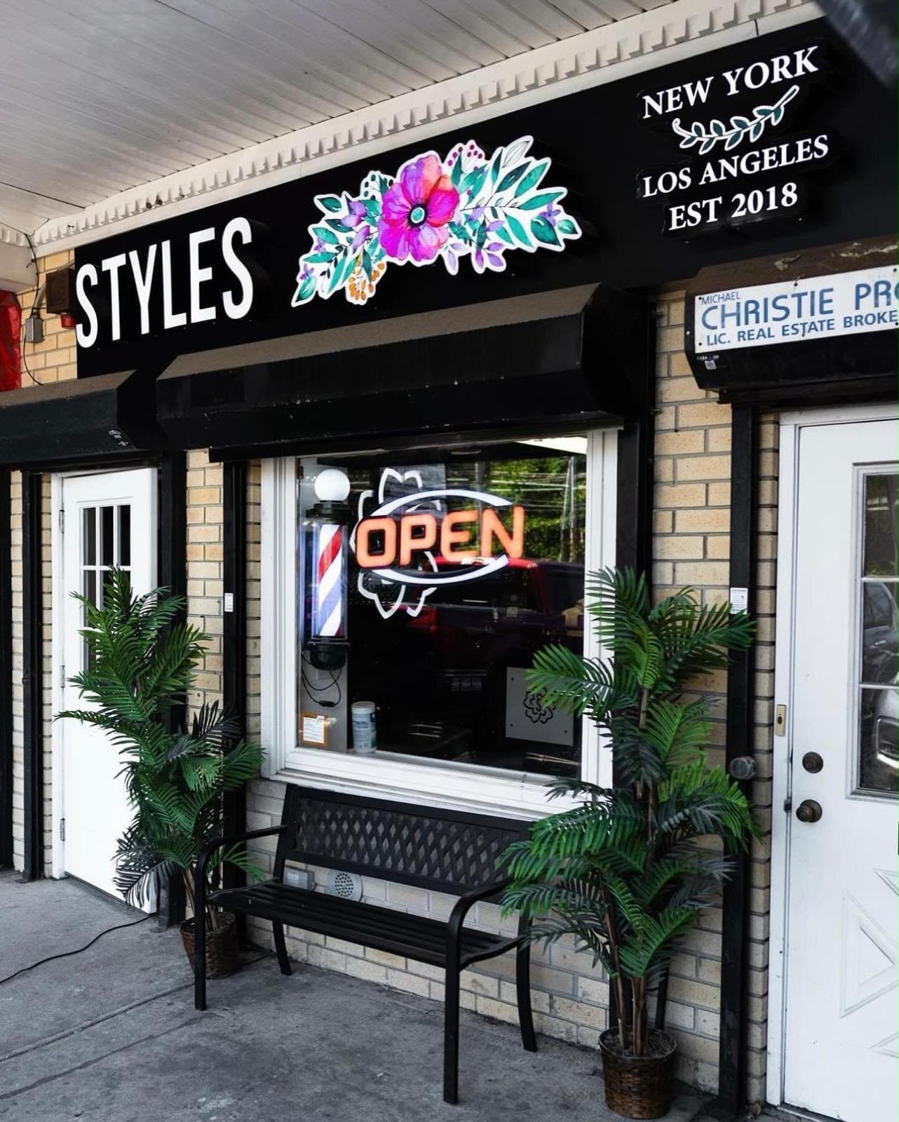 The bright marble interior of Styles Barber Lounge
